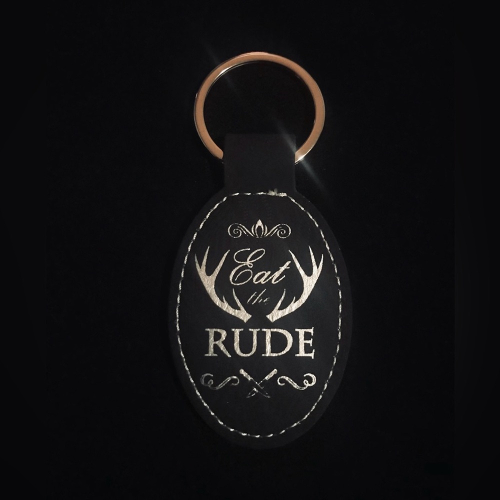 Hannibal “ Eat the Rude” laser engraved faux leather oval keychain